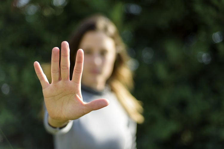 woman holding up hand